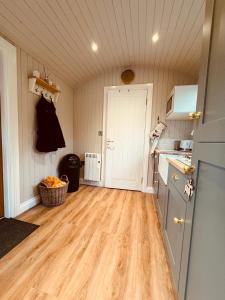 a kitchen with a wooden floor and a counter top at Southfield Shepards Huts in Durham