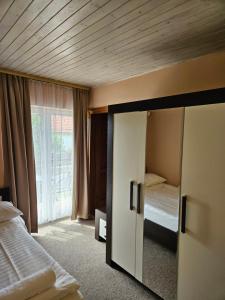 a bedroom with a bed and a sliding glass door at Villa Szófia in Siófok