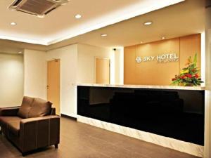 a lobby with a waiting room with a chair and a large screen at Sky Hotel Selayang in Batu Caves