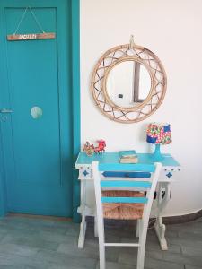 a blue desk with a mirror and a blue door at Villa Mondello Terraces & Jacuzzi in Mondello