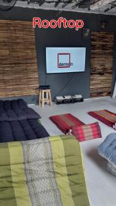 a room with a stage with a television and a bed at Dormsin Chill in Phi Phi Islands