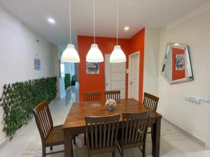 a dining room with a wooden table and chairs at Penang Mansion One Suites By AuroraHomes in George Town