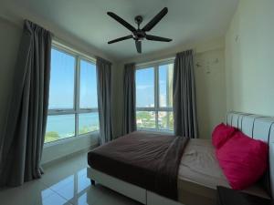 a bedroom with a bed and a ceiling fan at Penang Mansion One Suites By AuroraHomes in George Town