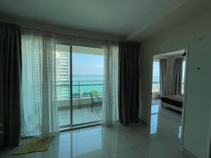 a room with a large window with a view of the ocean at Penang Mansion One Suites By AuroraHomes in George Town