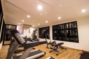 a gym with treadmills and cardio equipment in a room at Phu Dahla Apartments in Ban Khlong Haeng