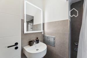 a bathroom with a white sink and a mirror at Day Young Life/ DYL Hosting 55 qm in Nürnberg +16 photos
