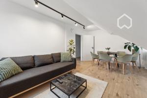 a living room with a couch and a table at Day Young Life/ DYL Hosting 55 qm in Nürnberg
