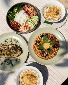 a group of plates of food on a table at Sumberkima Hill Retreat 2 in Pemuteran