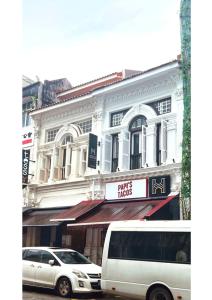 a white van parked in front of a building at Heritage Collection on Seah - A Digital Hotel in Singapore