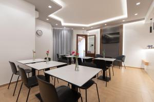 a dining room with white tables and chairs at Room & Breakfast Aloe in San Vito lo Capo