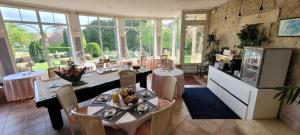 a kitchen and dining room with a table and chairs at Côté Jardin in Commercy +55 photos