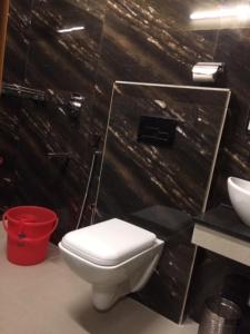 a bathroom with a white toilet and a sink at HOTEL BREEZE NEW JALPAIGURI in Siliguri