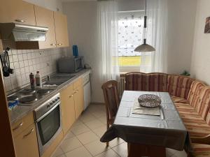 a kitchen with a table and a table and a couch at Ferienwohnung Lug in´s Land in Fichtelberg