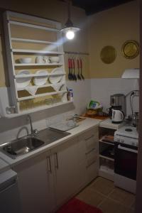 a small kitchen with a sink and a stove at Anemos - Holiday Beach Houses in Keratokampos
