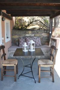 a table and two chairs on a patio at Anemos - Holiday Beach Houses in Keratokampos