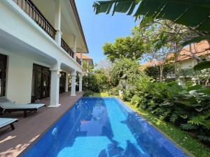 a swimming pool in the backyard of a villa at Tropical Pool Villas Da Nang in Da Nang
