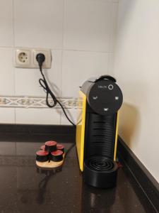 a hair dryer sitting on a counter next to cupcakes at Villa dos castanheiros in Cascais