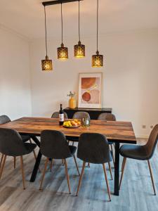 a dining room with a wooden table and chairs at Villa dos castanheiros in Cascais