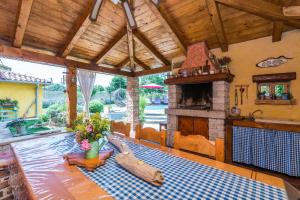 a dining room with a table and a fireplace at Ferienhaus mit Privatpool für 6 Personen ca 140 qm in Svetvincenat, Istrien Binnenland von Istrien in Pula