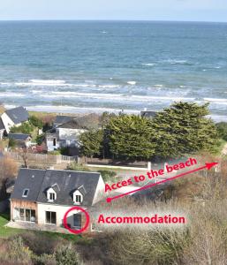 an aerial view of a house next to the ocean at Les Néreides in Saint-Laurent-sur-Mer
