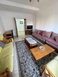 a living room with two couches and a coffee table at bel appart mosta in Mostaganem