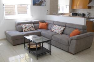 ein Wohnzimmer mit einem Sofa und einem Tisch in der Unterkunft Sunset Villa private complex heated pool in Ayia Napa