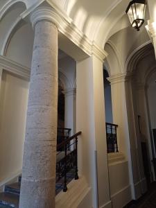 a column in a building with a staircase at Andrassy Boulevard in Budapest