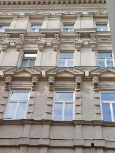 a tall building with windows on the side of it at Andrassy Boulevard in Budapest