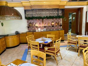 a dining room with a table and chairs at Maharaja Oriental Suite Makati in Manila