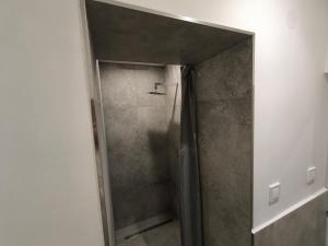 a shower with a glass door in a bathroom at ApartmanyHurbanova1 in Bardejov