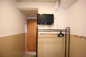 a flat screen tv on the wall of a room at Comfort Hostel in Hong Kong