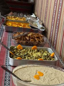 a bunch of trays of food on a table at Wadi Rum Magic Camp in Wadi Rum