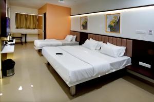 Postel nebo postele na pokoji v ubytování Hotel Haldi