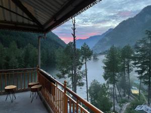 a balcony with a view of a lake and mountains at Highland spirit 2 in Kasol