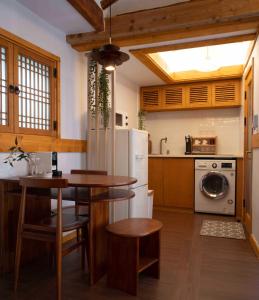 a kitchen with a table and a refrigerator at Luxury hanok with private bathtub - SW02 in Seoul