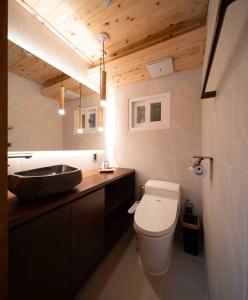 a bathroom with a white toilet and a sink at Luxury hanok with private bathtub - SW02 in Seoul