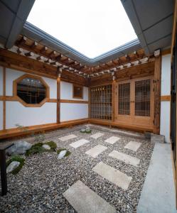a japanese garden with a roof and a courtyard at Luxury hanok with private bathtub - SW02 in Seoul