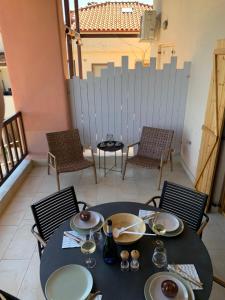 a table and chairs in a room with a fence at Sunrise Studio Afitos in Afitos