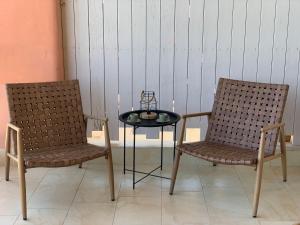 due sedie e un tavolo con una candela tra di loro di Sunrise Studio Afitos ad Áfitos