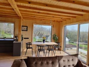 a living room with a table and chairs at Modern family house by the lake in Zarasai in Štadviliai +18 photos