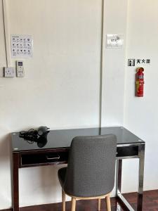 a desk with a chair in a room at Seladah Stay in Kuching