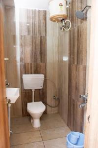 a bathroom with a toilet and a sink at Hotel Grand Stay in Bhopal +17 photos