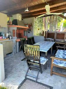 a patio with a table and chairs and a kitchen at Thea apartments 3 in Platamonas +11 photos