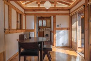 a kitchen with a table and chairs in a room at Luxury hanok with private bathtub - Yoojundang in Seoul