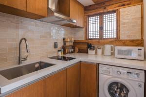 a kitchen with a washing machine and a sink at Luxury hanok with private bathtub - SN02 in Seoul