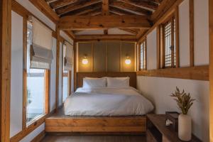 a bedroom with a bed and a window at Luxury hanok with private bathtub - Yoojundang in Seoul