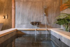 a bath tub with a water fountain in it at Luxury hanok with private bathtub - SN02 in Seoul