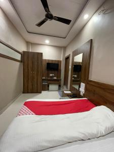 a bedroom with a bed with a ceiling fan at Hotel Grand Stay in Bhopal