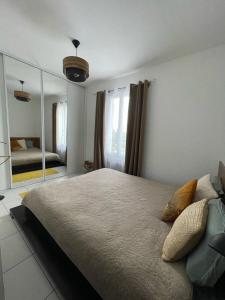 a bedroom with a large bed and a mirror at Maison entière Redessan in Redessan
