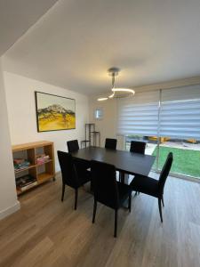 a dining room with a black table and chairs at Maison entière Redessan in Redessan +12 photos